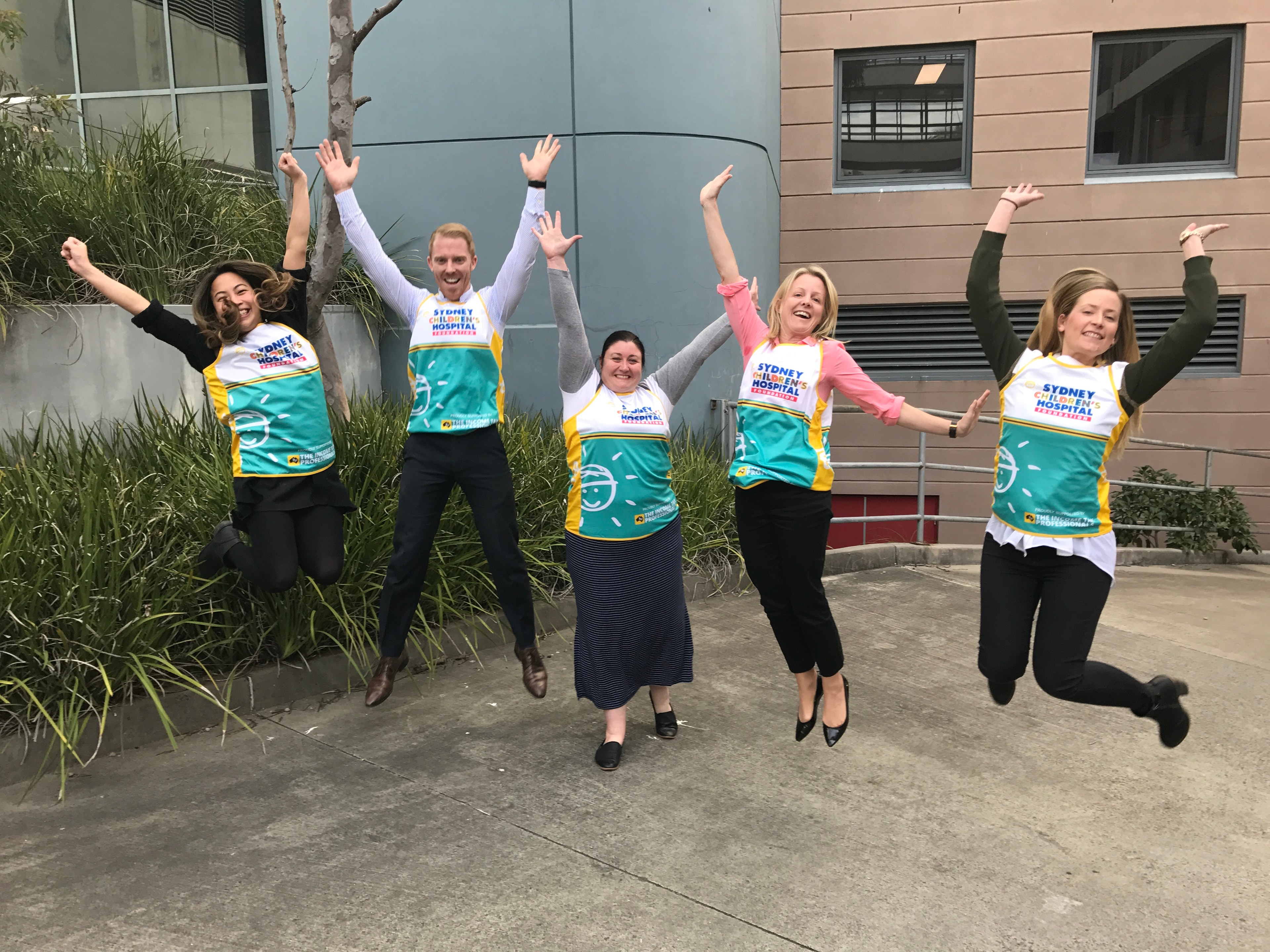 Group jumping and celebrating outside Sydney Children's Hospital