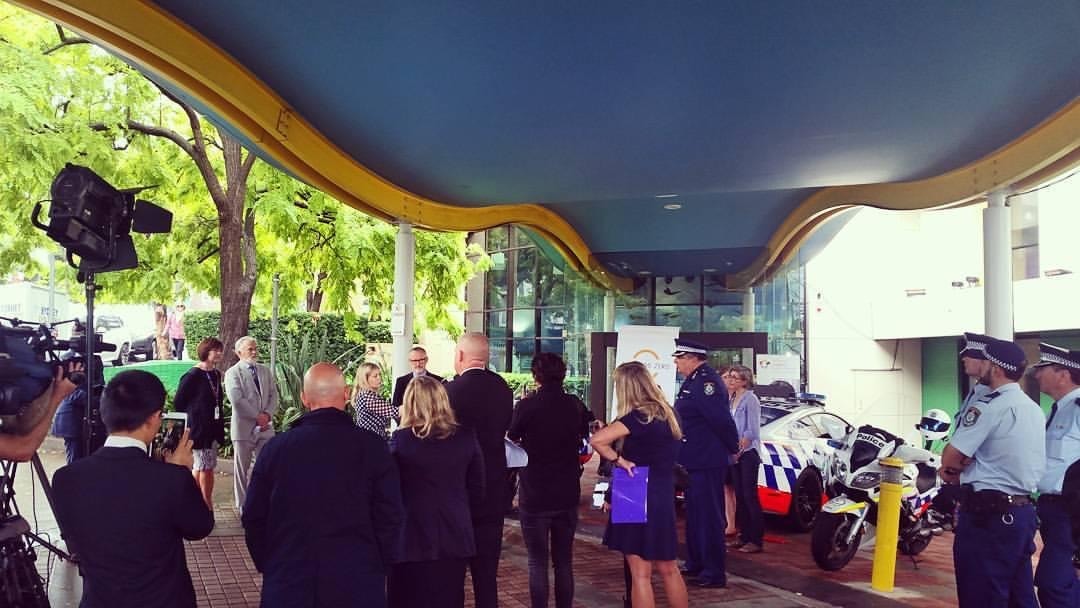Official event with police motorcycles and media at hospital